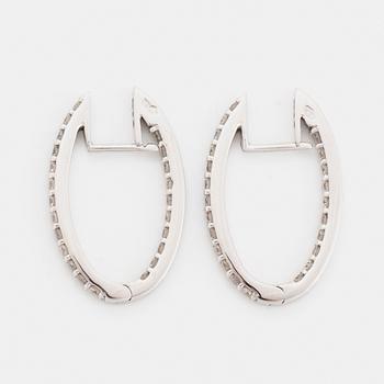 Brilliant-cut diamond hoop earrings.