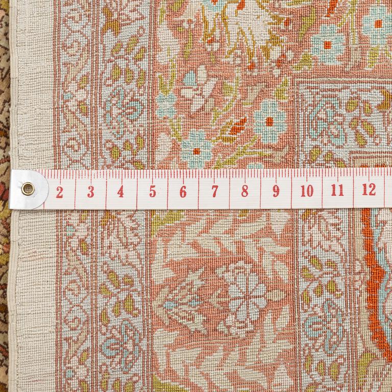 A silk Hereke rug, c. 85 x 55 cm.