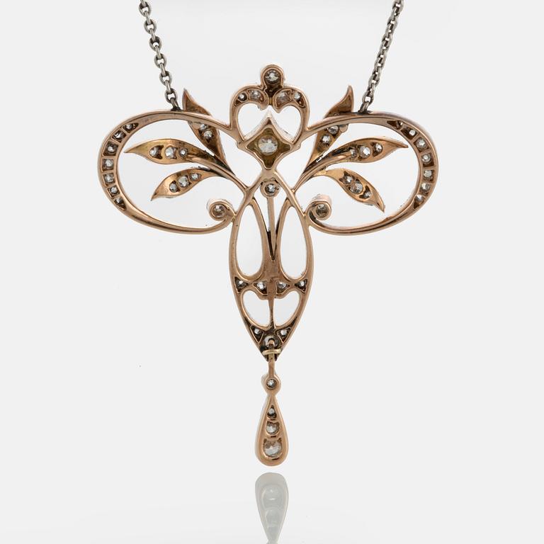 A pendant in platinum and 14K gold set with old- and rose-cut diamonds.