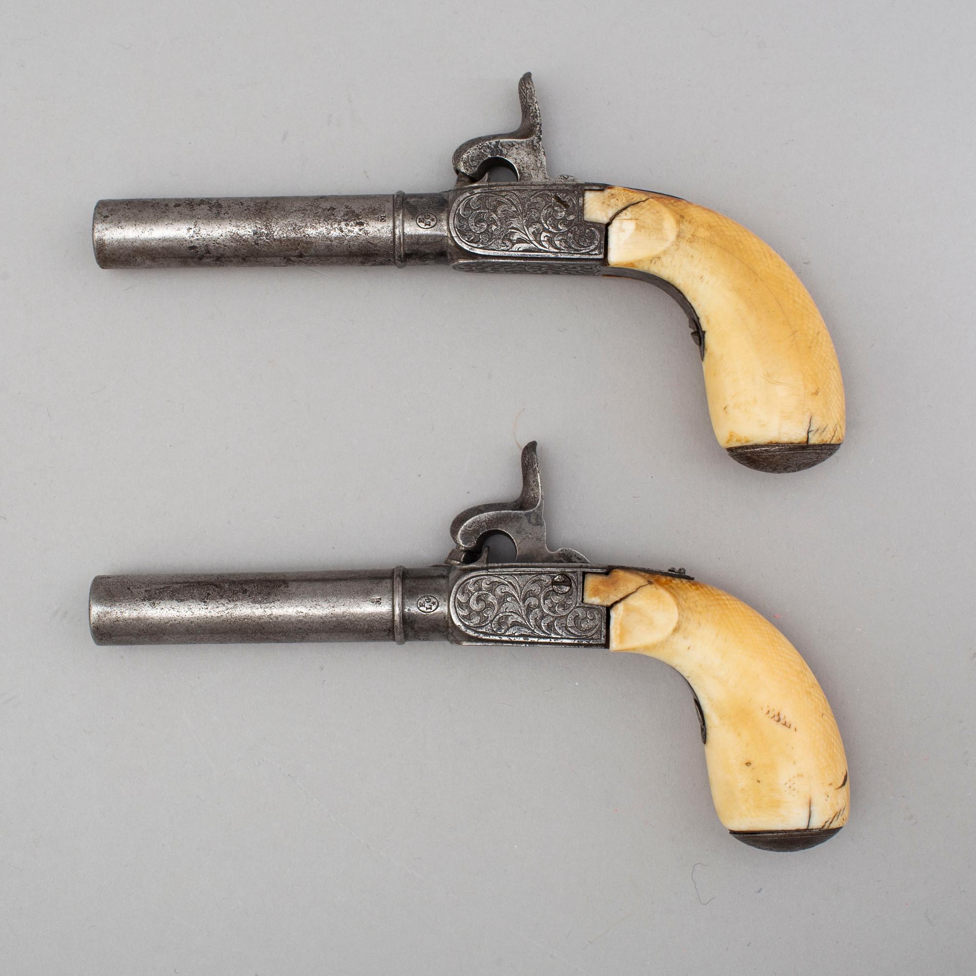 A mid 19th century Belgian rifled percussion pistols with ivory butts in a case.