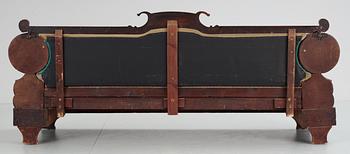 A mahogny veneer Empire sofa. 19th Century.