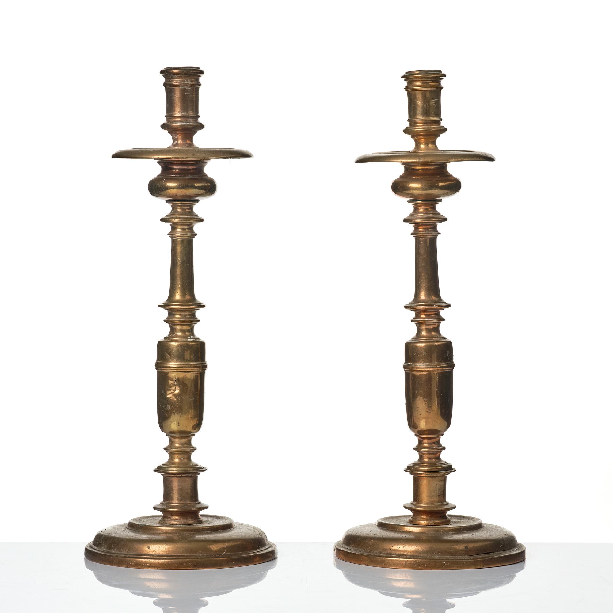 A pair of baroque brass candlesticks, 18th century.