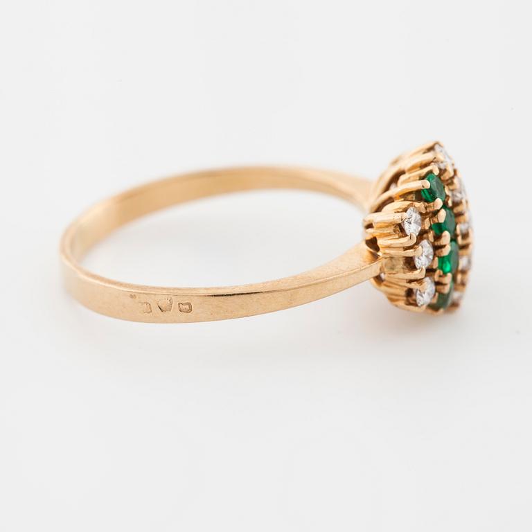 An emerald and brilliant cut diamond ring.