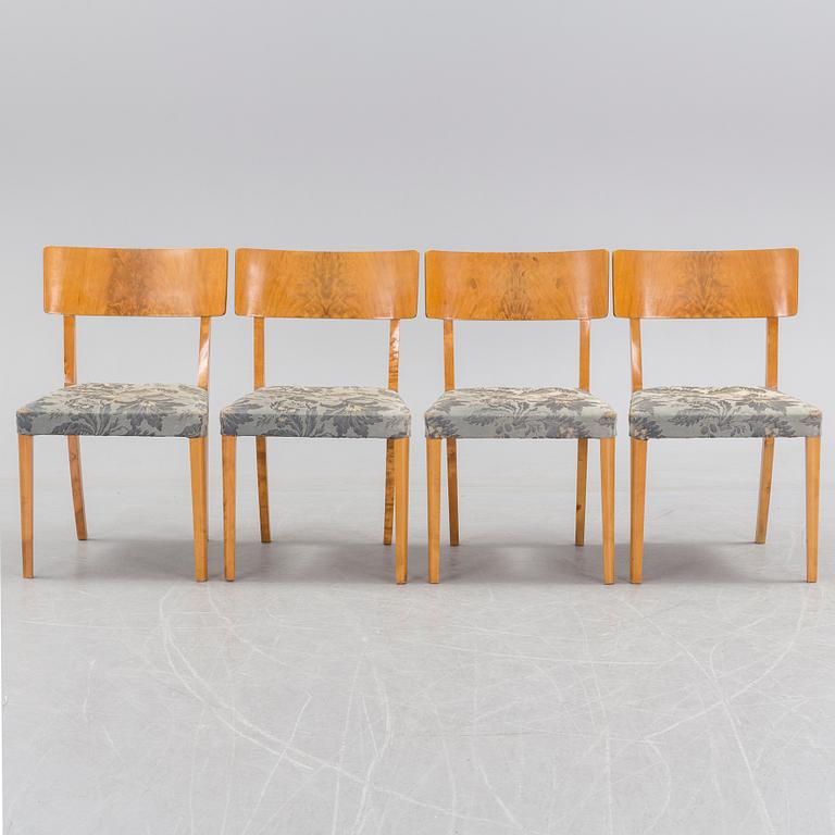 A 1940's dining table an four chairs.