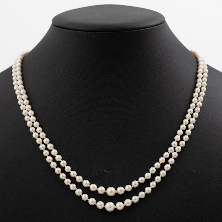 Double-row necklace with graduated cultured pearls, silver clasp set with paste stones.