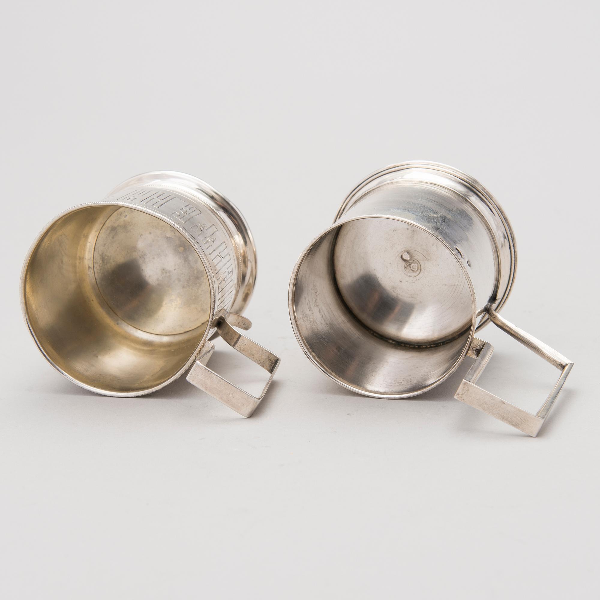 Two tea glass holders in silver, one with mark of Ivan Saltykov, Moscow 1889, the other one marked Moscow 1908-1917.