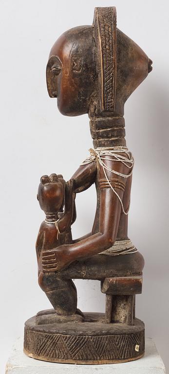 A sculptue and two masks reportedly from The Ivory coast, from the second half of the 20:th century.