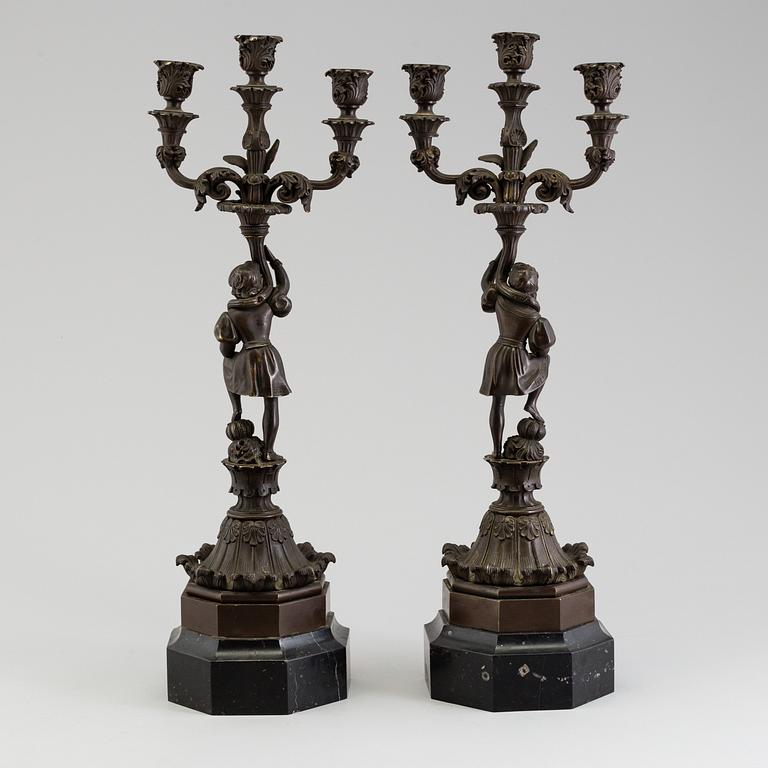A pair of late 19th century patinated brass candelabra.
