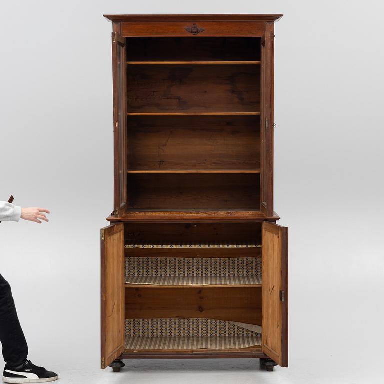 A two part mahogany cabinet, around 1900.