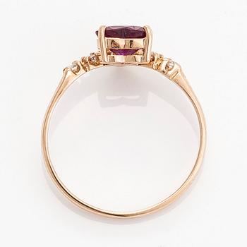 A 14K gold ring, with a heart-shaped ruby and diamonds.