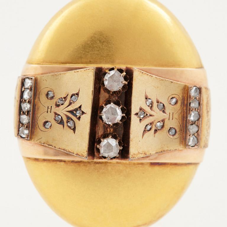 An 18K gold locket set with rose-cut diamonds.