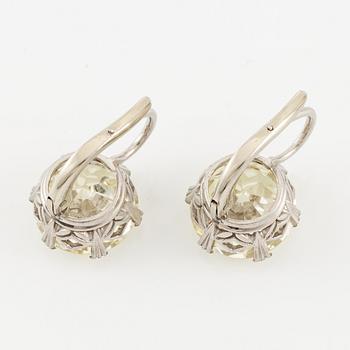 A pair of earrings in 18K white gold set with two old-cut diamonds.