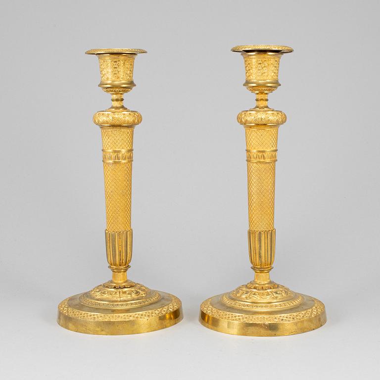 A pair of ormolu candlesticks, first half of the 19th century.