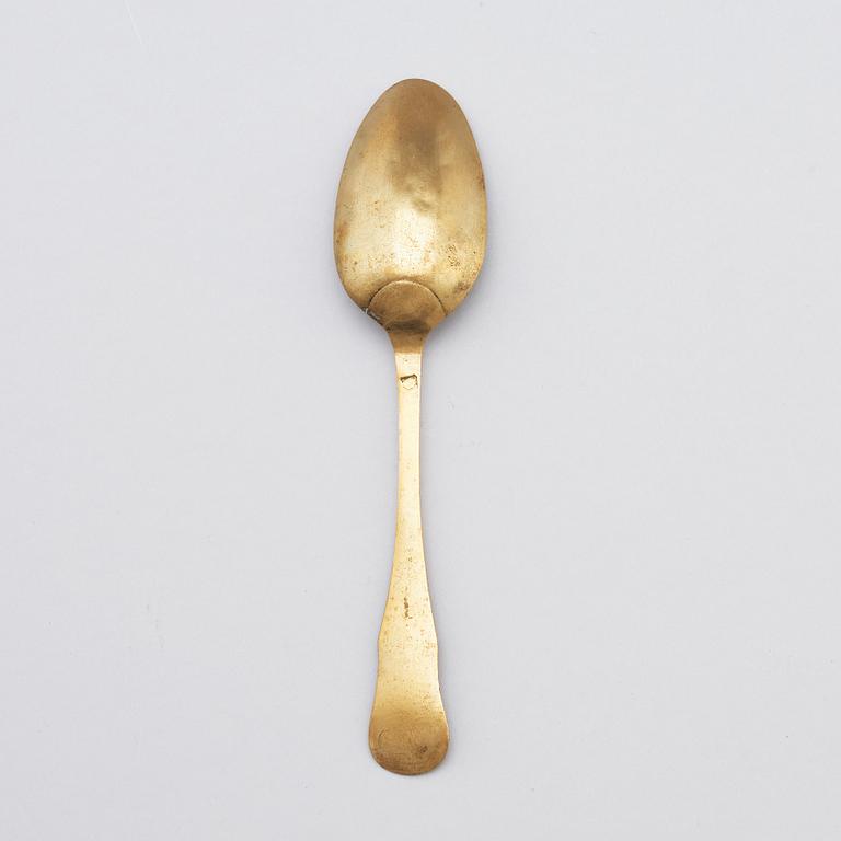 A brass (originally silver plated) spoon by Erik Castman.