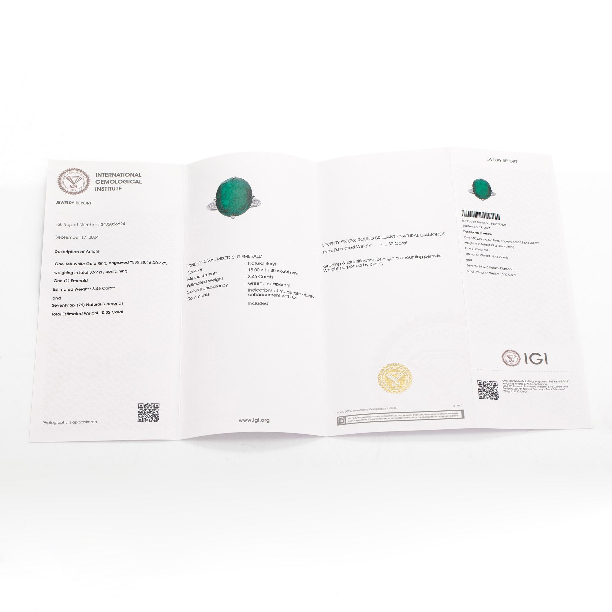 A 14K white gold ring, set with an oval-cut emerald and diamonds. Accompanied with IGI certificate.