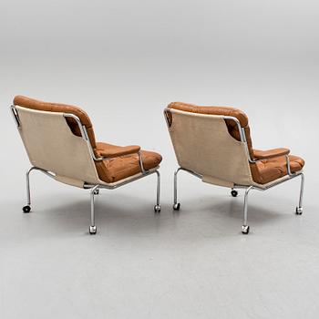 A pair of leather upholstered easy chairs, 1960's/70's.