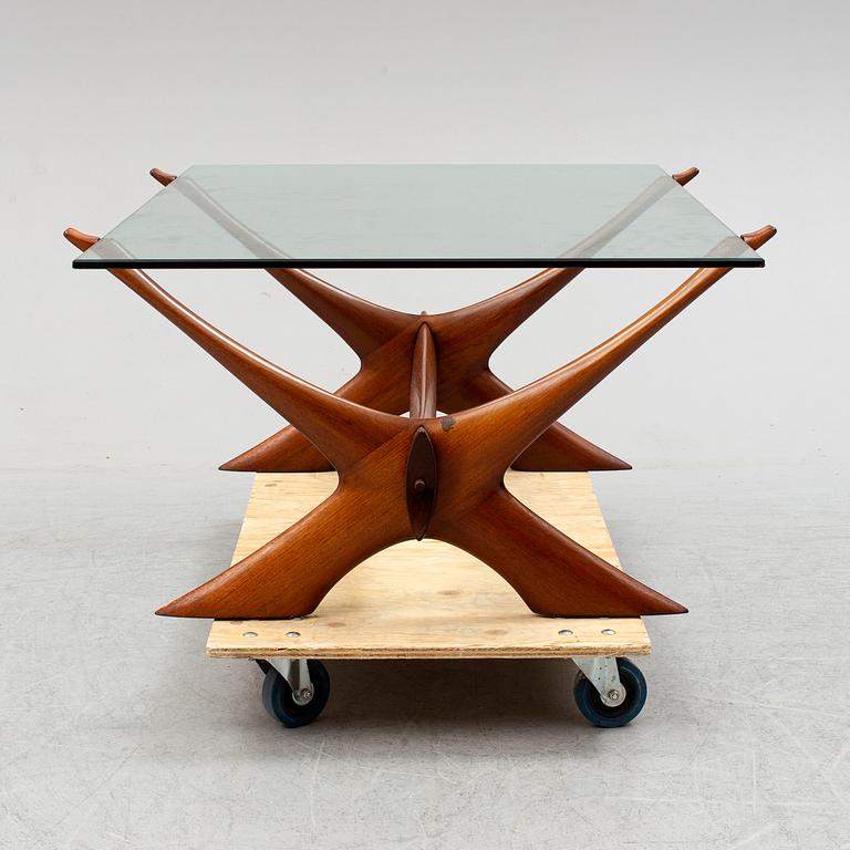 A glass top coffee table by Fredrik Schriever Abeln.