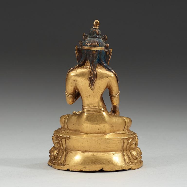 A partly gilt and painted Tibeto-Chinese bronze figure of White Tara, 18th Century.