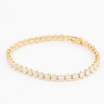 Tennis bracelet in 18K gold with brilliant-cut diamonds.