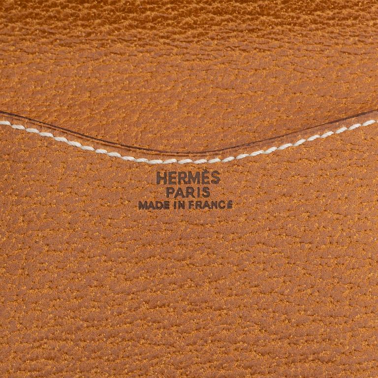 Hermès, a brown leather case for sunglasses.