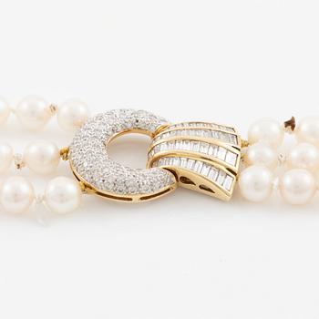 Pearl necklace, three strands of cultured pearls, clasp in 18K gold set with baguette and brilliant-cut diamonds.