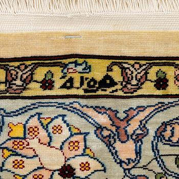 A silk Hereke rug, Turkey, approx. 82 x 58 cm.