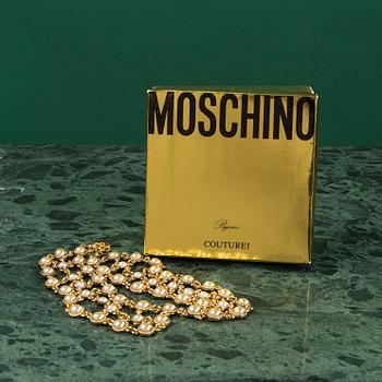 A necklace by MOSCHINO.