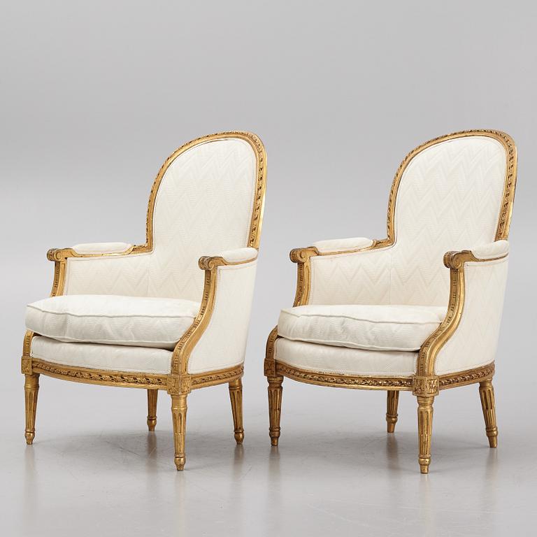 A near pair of French Louis XVI giltwood bergères, Paris, late 18th century.