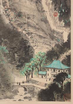 Zhang Renzhi, A hanging scroll of a rocky landscape with a river valley and house, signed.