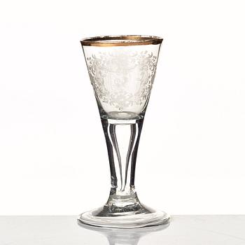 An engraved and gilded armorial wine glass, 18th Century.