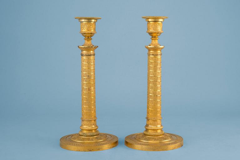 A PAIR OF EMPIRE CANDLESTICKS.