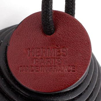 HERMÈS, a black leather necklace.