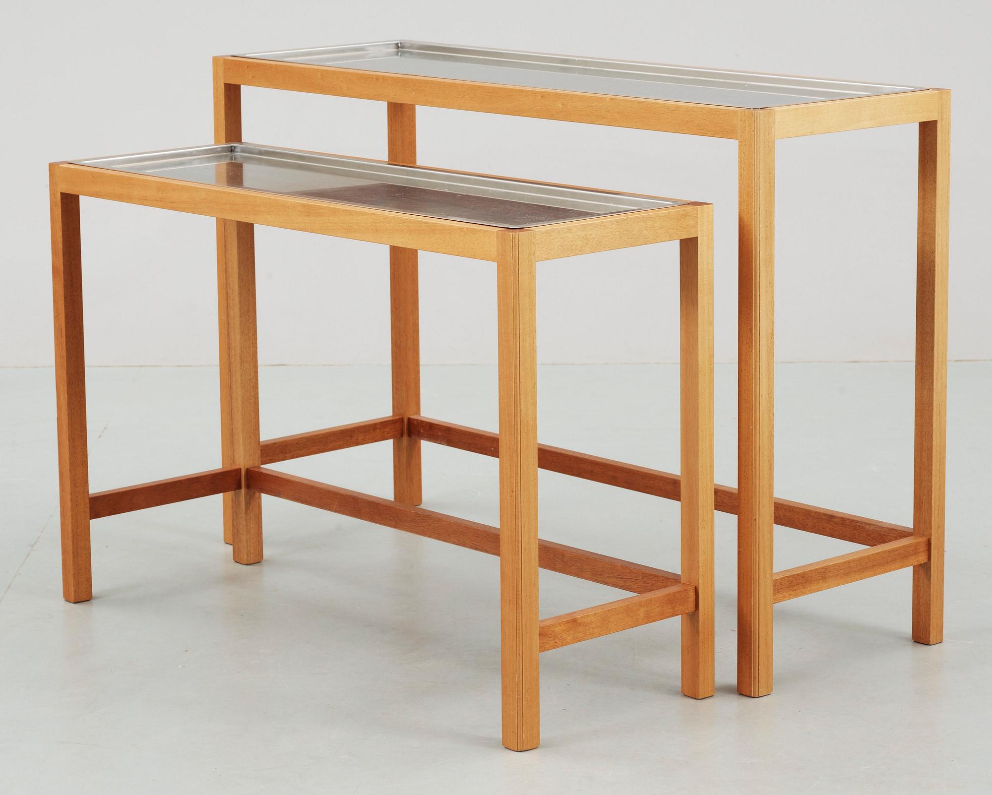 A Josef Frank set of mahogany and stainless steel tables by Svenskt Tenn.