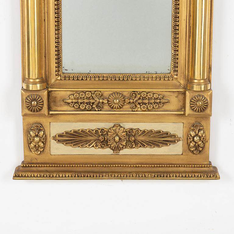 An Empire mirror, first half of the 19th century.