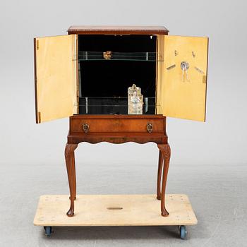 A mid 20th century walnut veneered bar cabinet.