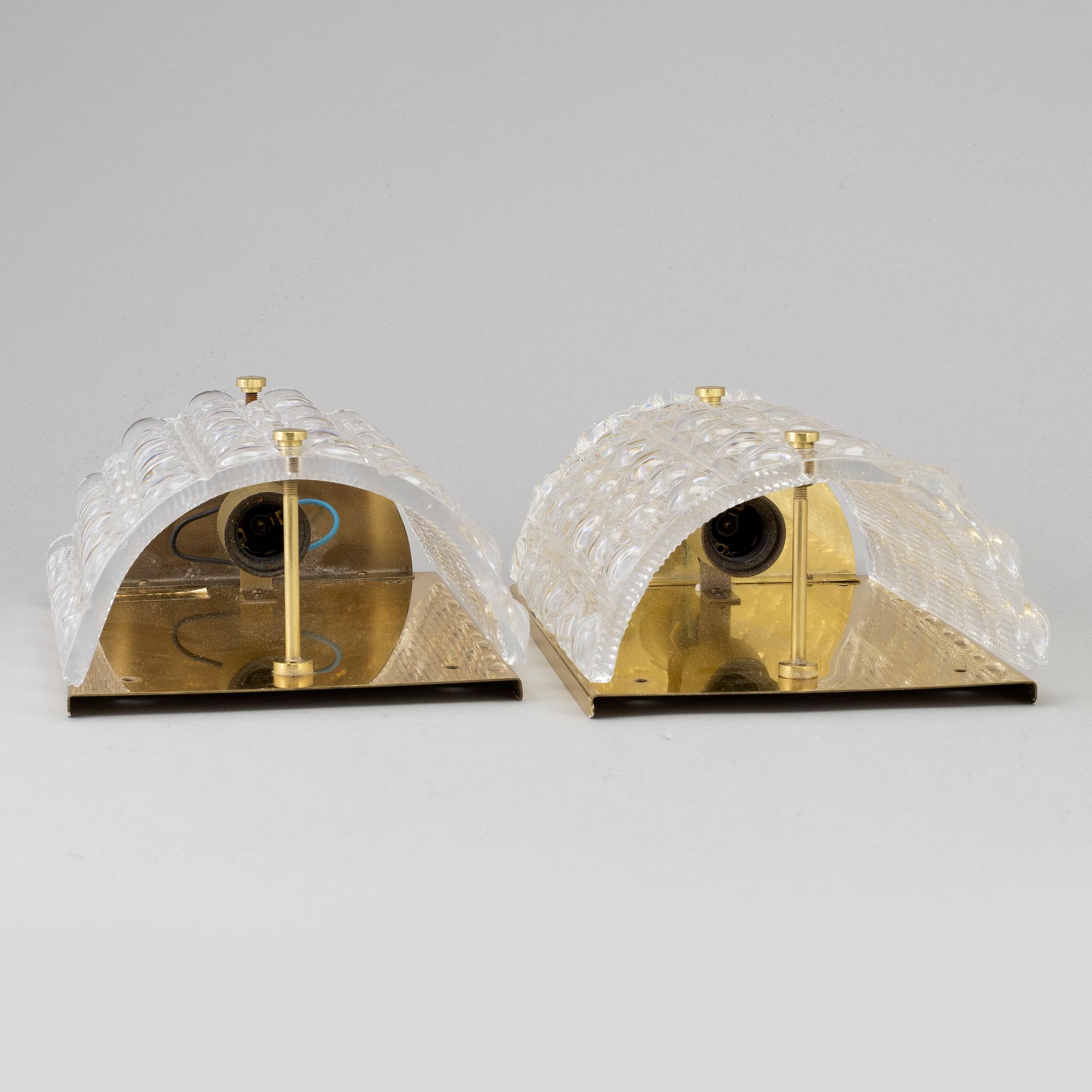 CARL FAGERLUND, a pair of brass and glass wall lights, Orrefors.