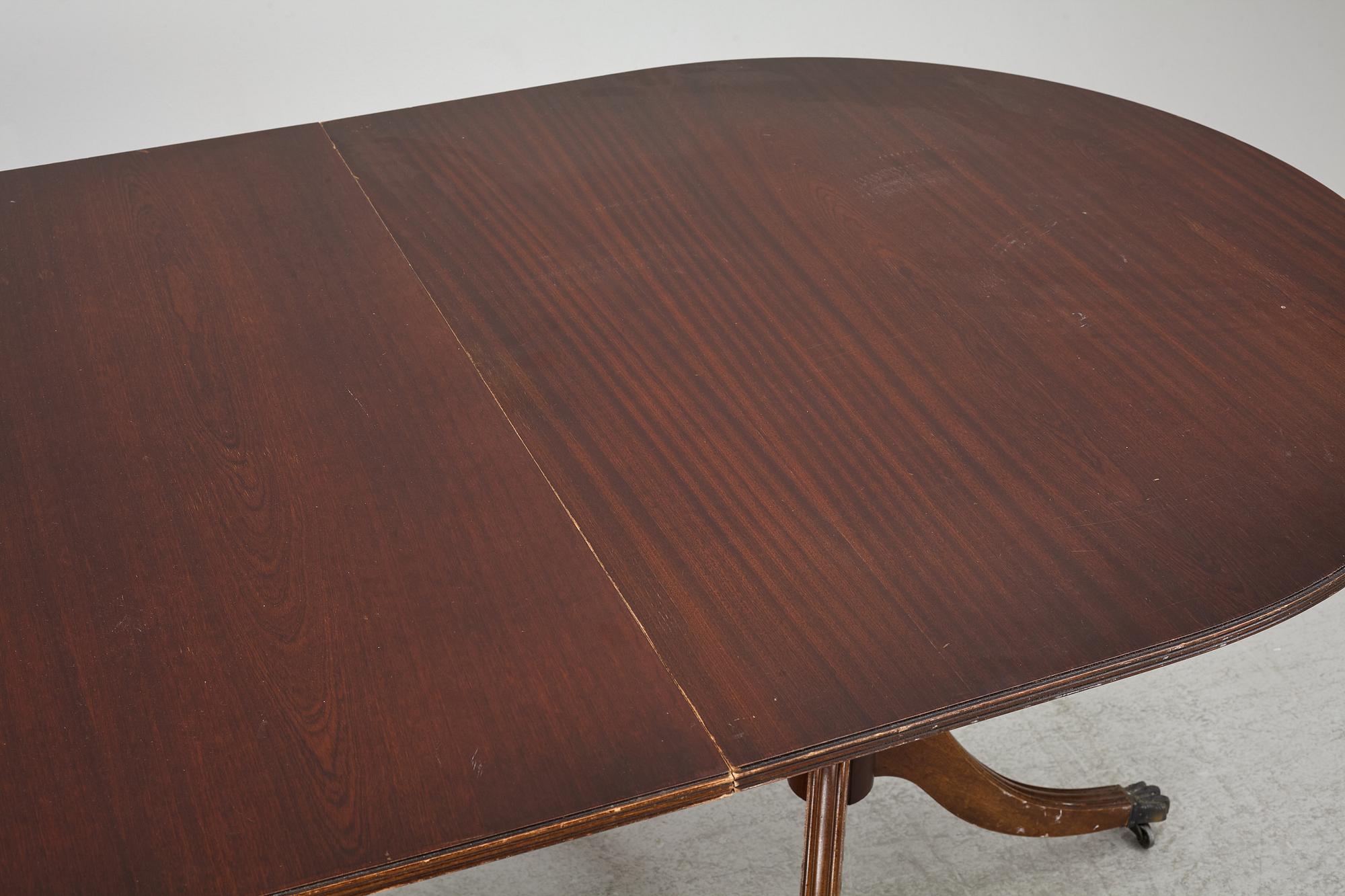 A dining table, 20th century, England.