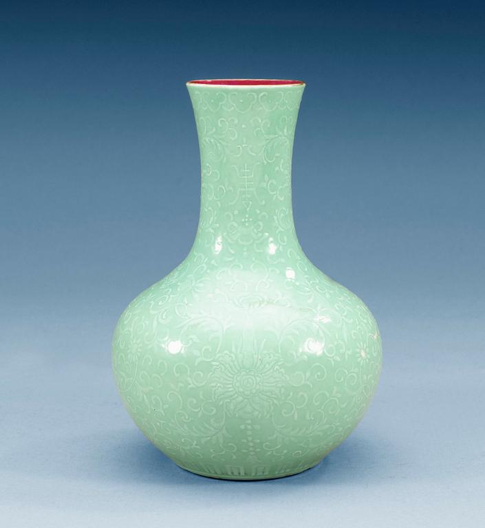 A turkoise-ground white enamelled vase, Qing dynasty (1644-1912) with Qianlong four character mark.