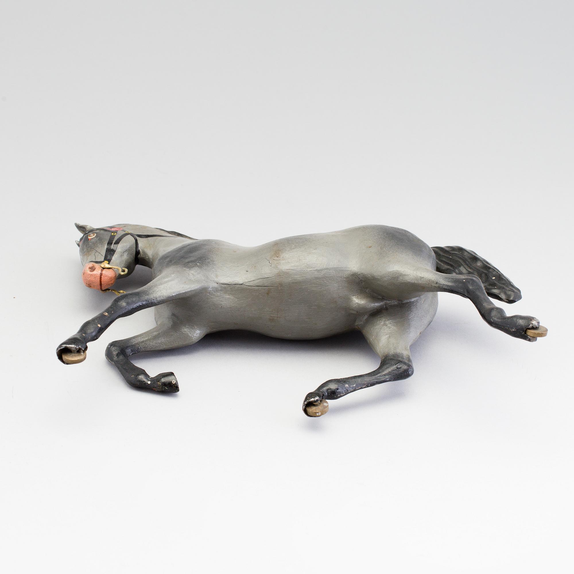 A painted tinplate toy horse ca year 1900.