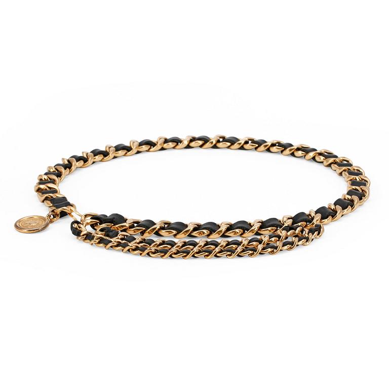 CHANEL, a black leather and gold colored chain belt.