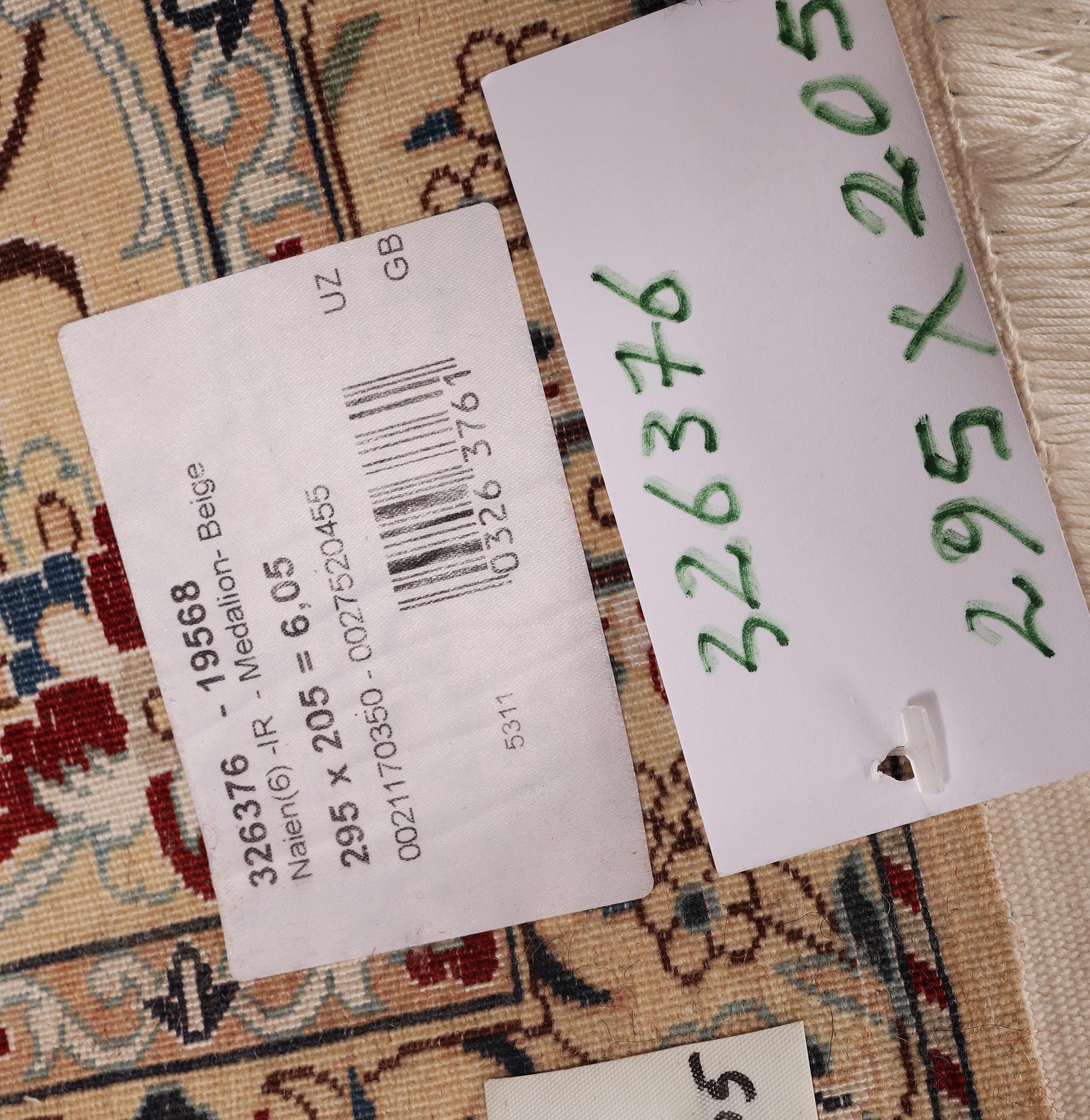 A Nain carpet, part silk, signed, 6 laa, c. 295 x 205 cm.