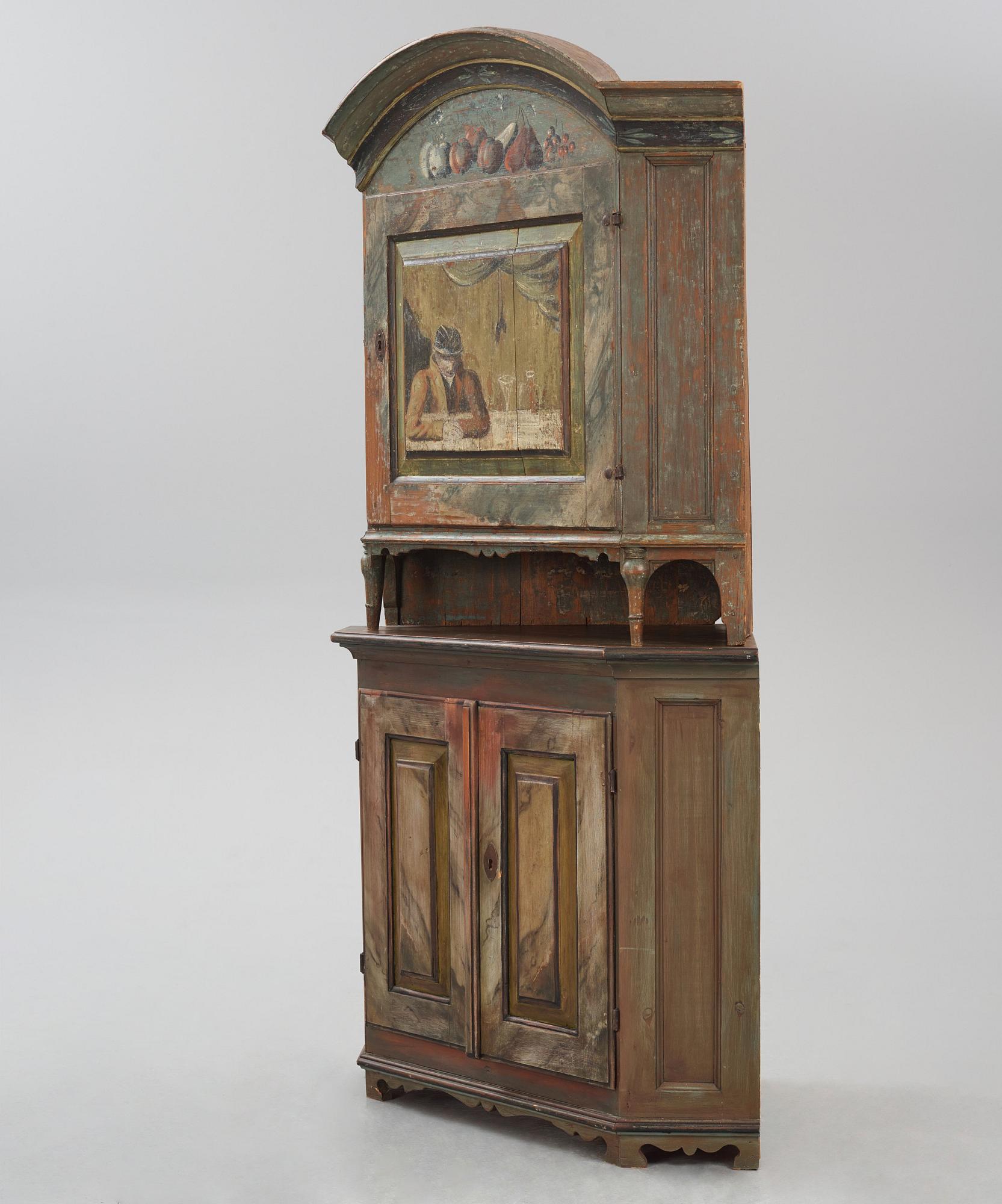 A Swedish polychrome-painted corner cabinet attributed to J. Bäckström (1773-1837).