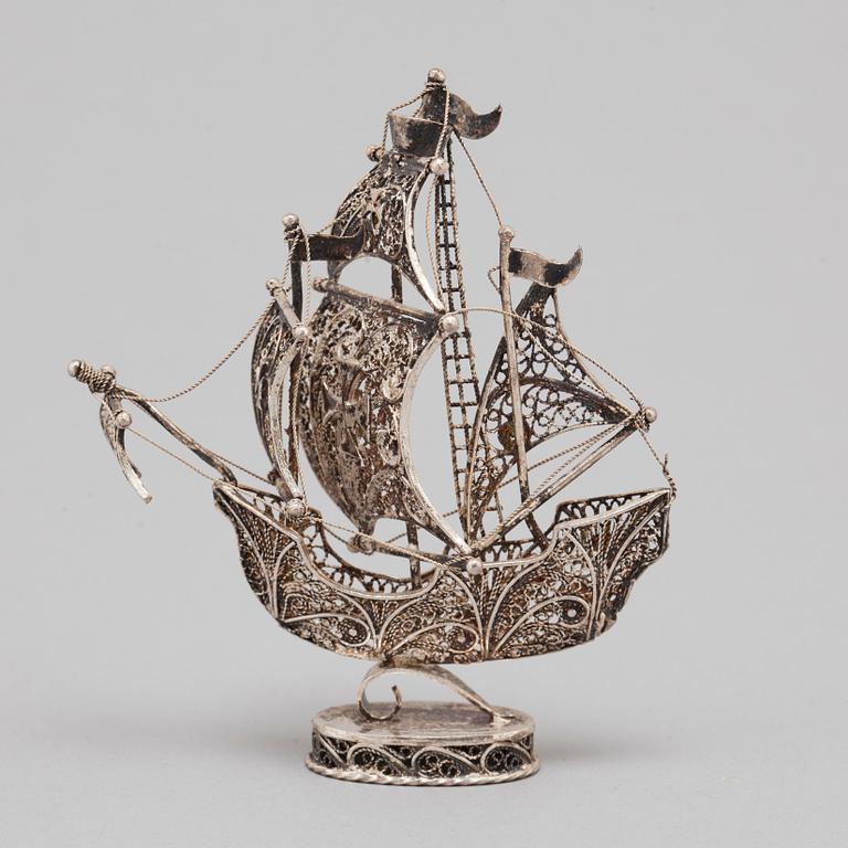 A 20TH CENTURY SILVER MINIATURE SAILING SHIP.