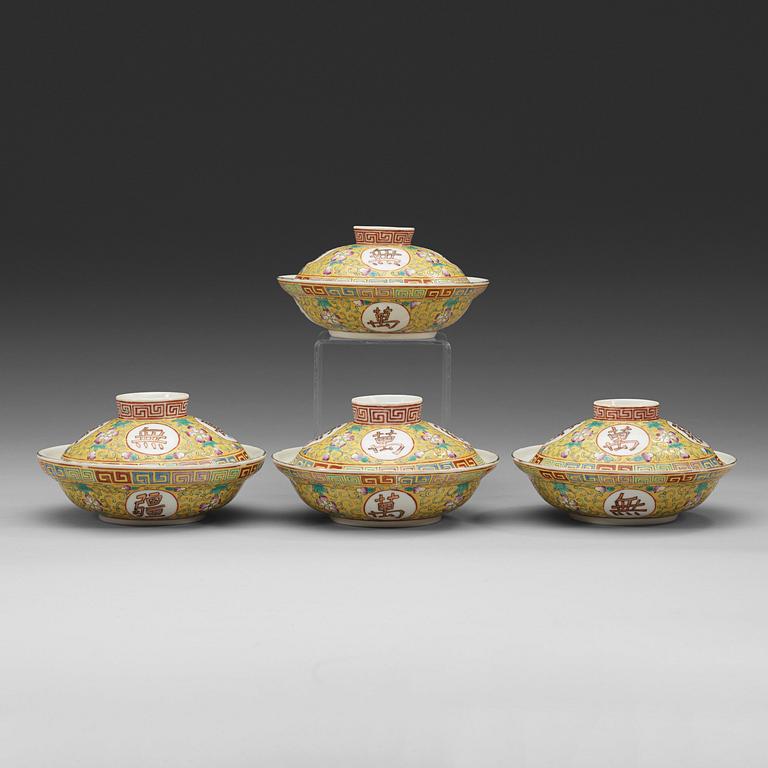 A set of four yellow ground famille rose bowls with covers, early 20th century with Guangxu six character mark in red.