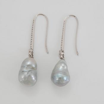 A pair of cultured South Sea pearl earrings in 18K white gold set with round brilliant-cut diamonds.