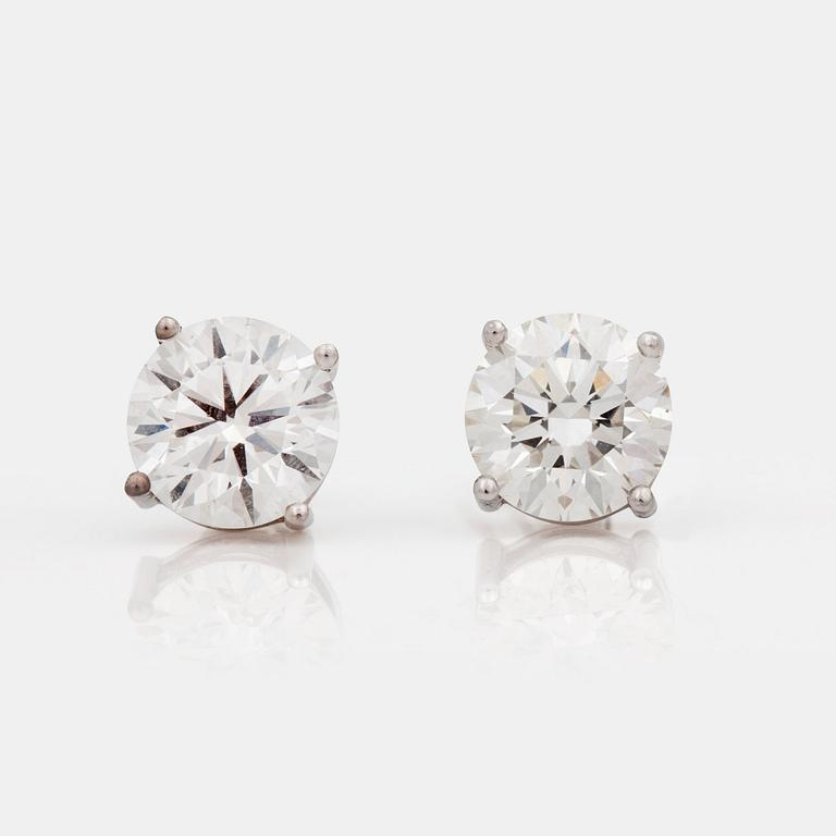A pair of brilliant-cut diamond earrings, total carat weight 4.10cts. Quality H/VS1. IGI certificates.