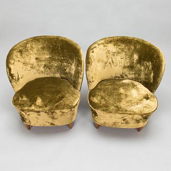 A pair of mid-20th-century armchairs.