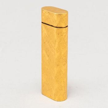 A gilt steel lighter from les must de Cartier.