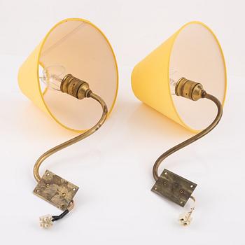 A pair of brass wall lamps.