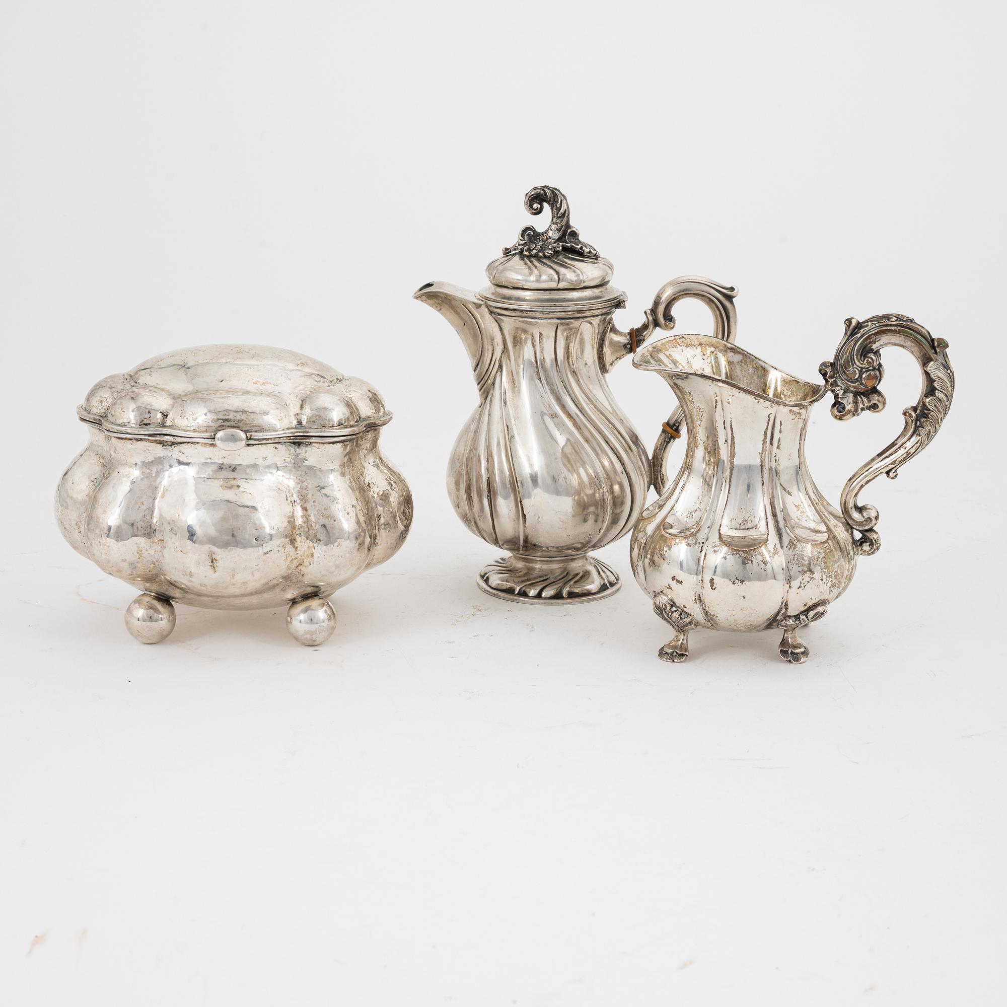 A Rococo style silver sugarbox and two creamers, including Lars Larsson ...